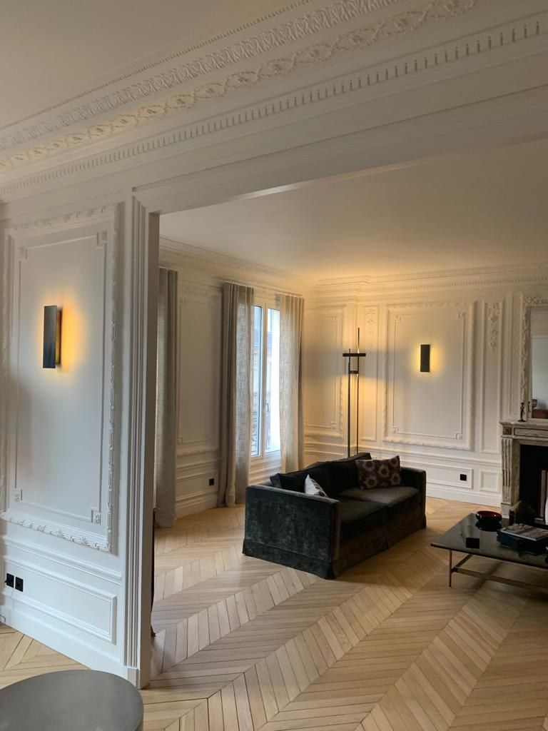 Salon avec cheminée conservée et corniches reprises, dans un appartement entièrement rénové